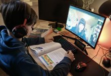 Teenage boy participating in a group discussion via video chat during distance learning