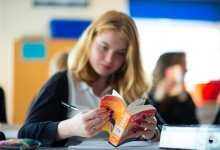 Student reading a Spanish language dictionary