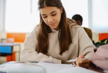 Teenager writing in class