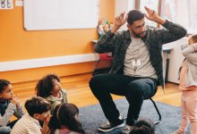 Teacher and student making poses during a game