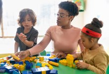 Teacher and student working with building blocks