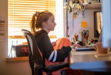Middle school aged girl at computer distance learning