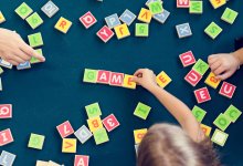 Photo of students spelling words with blocks